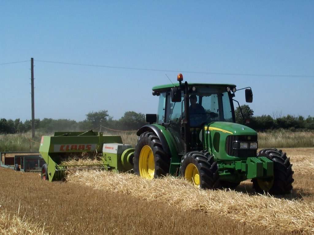 Tractor bailing straw