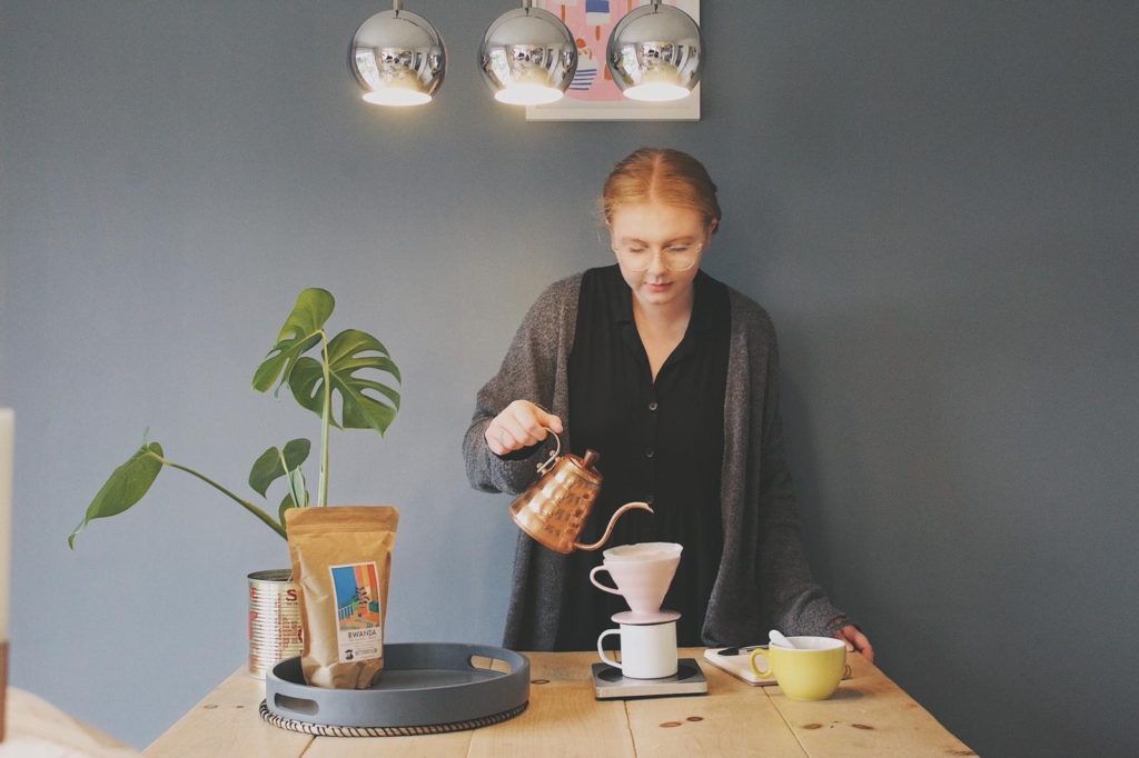 Nelly Keen pouring a cup of coffee at Applaud Coffee in Ipswich, where she started as an apprentice.